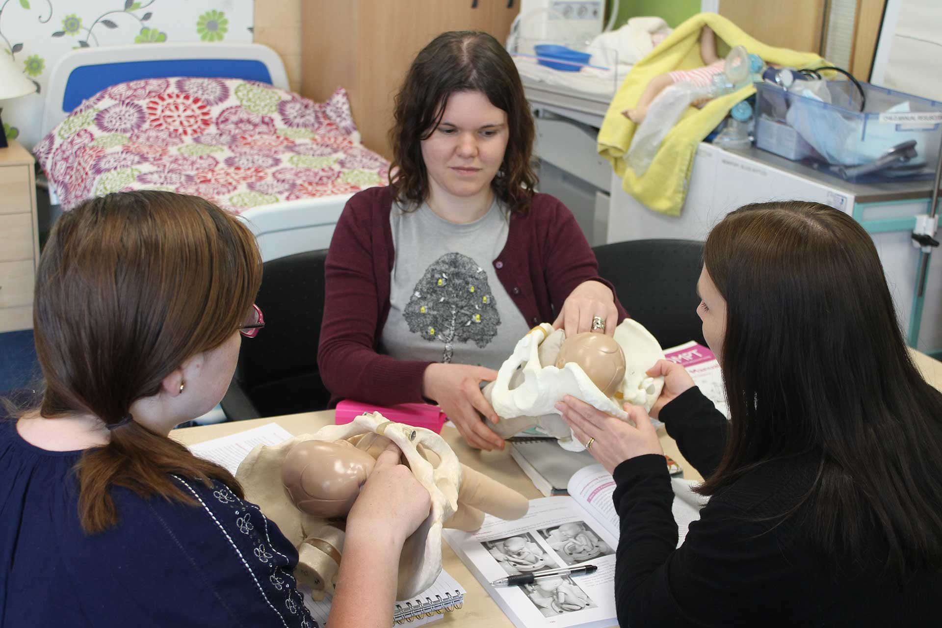 Students in clinical session with baby in pelvis