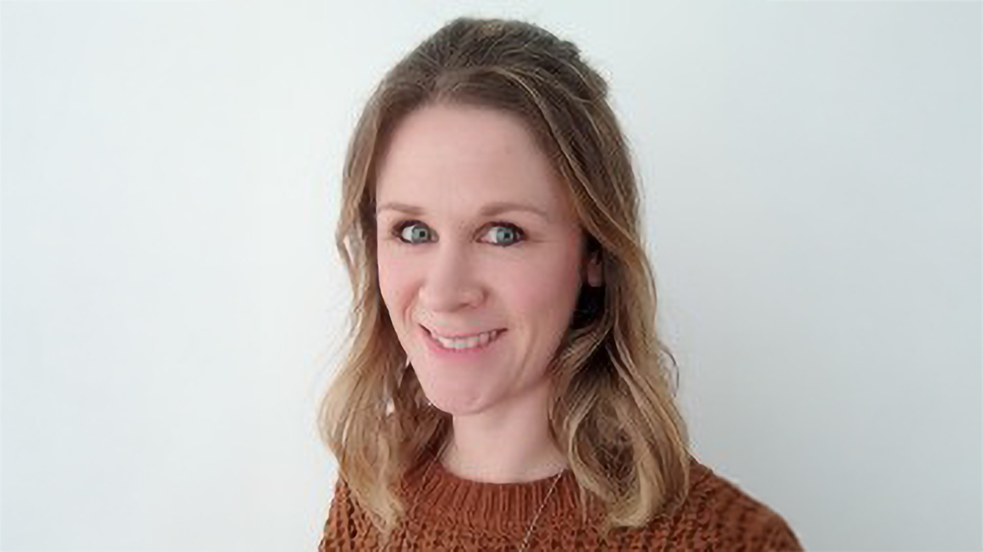 A headshot of Emily Spence on a plain background