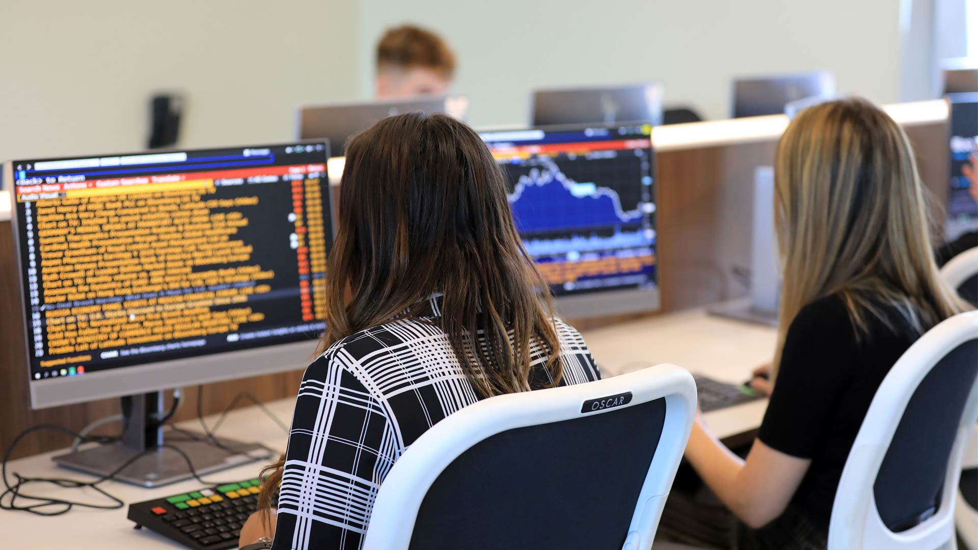 Students using Trading Room Terminal at Huddersfield Business School