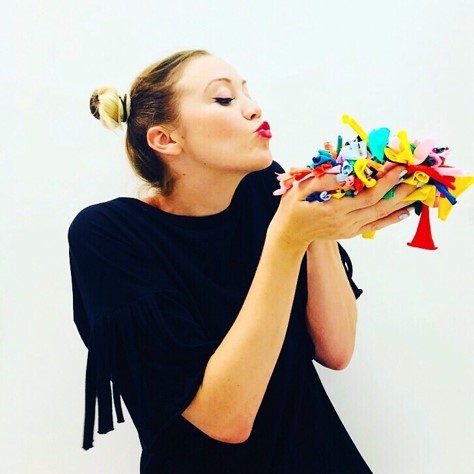 Fashion alumni with handful of colourful material