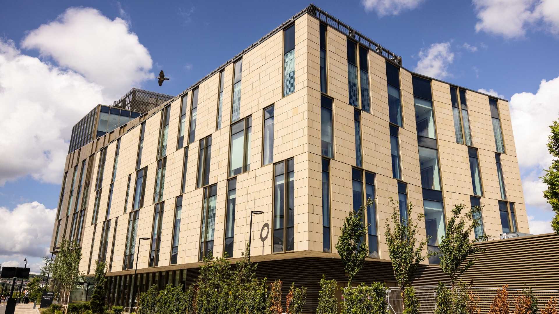 A modern angular building against a blue sky