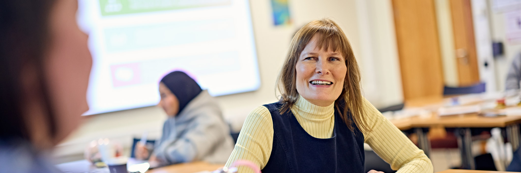 Tutor speaking with students on the Lifelong Learning course
