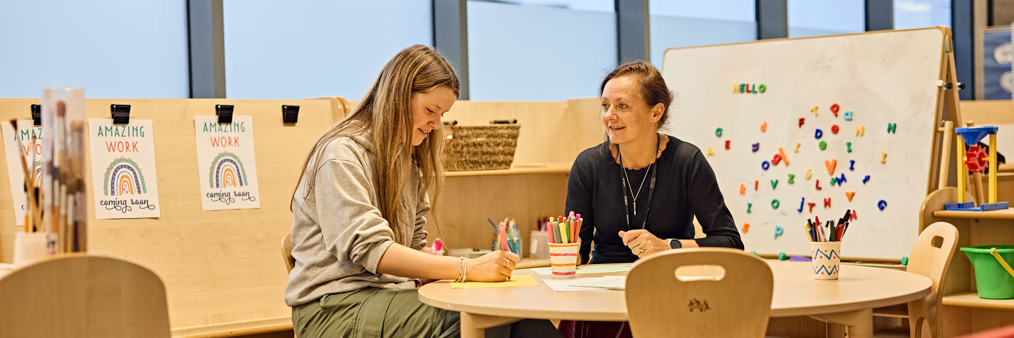 Student at with academic in dedicated early years and primary teaching space