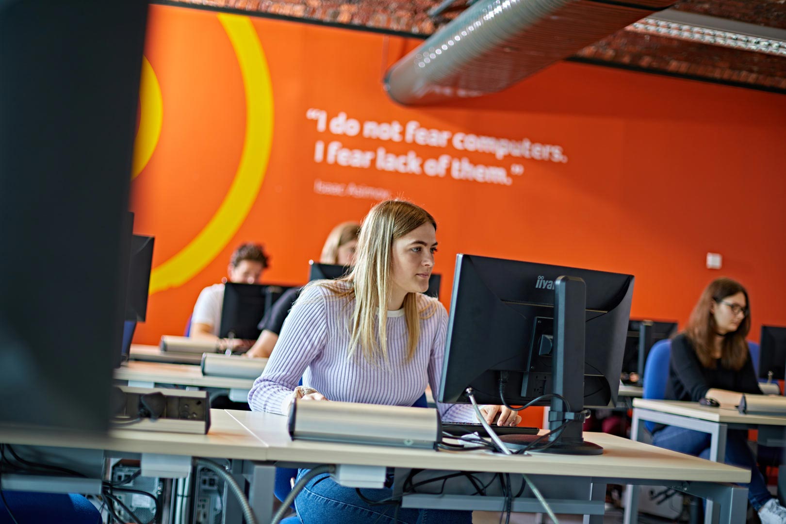 Female student in a Information Technology seminar in the School of Computing and Engineering