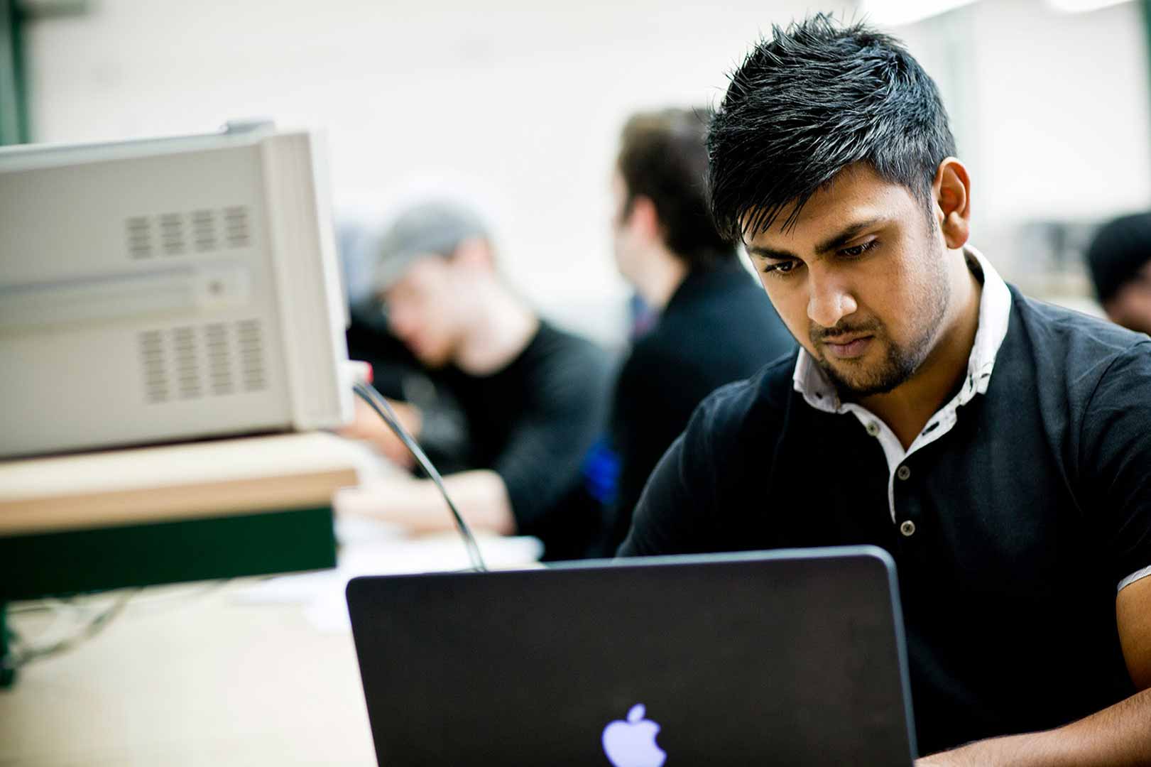 Student in class using a laptop