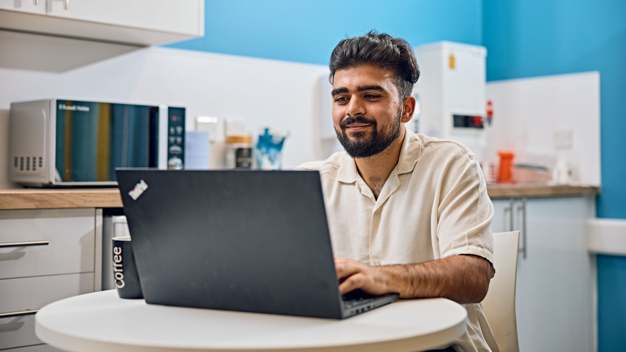 Student with laptop in accommodation