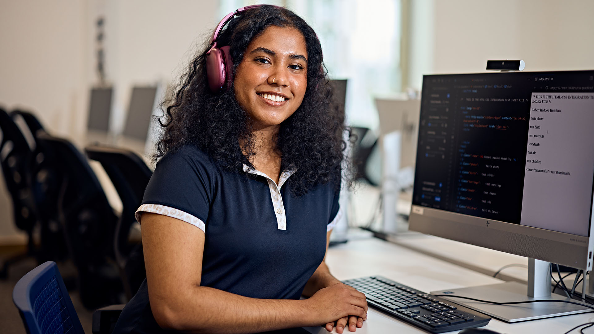 Student smiling in a computer lab
