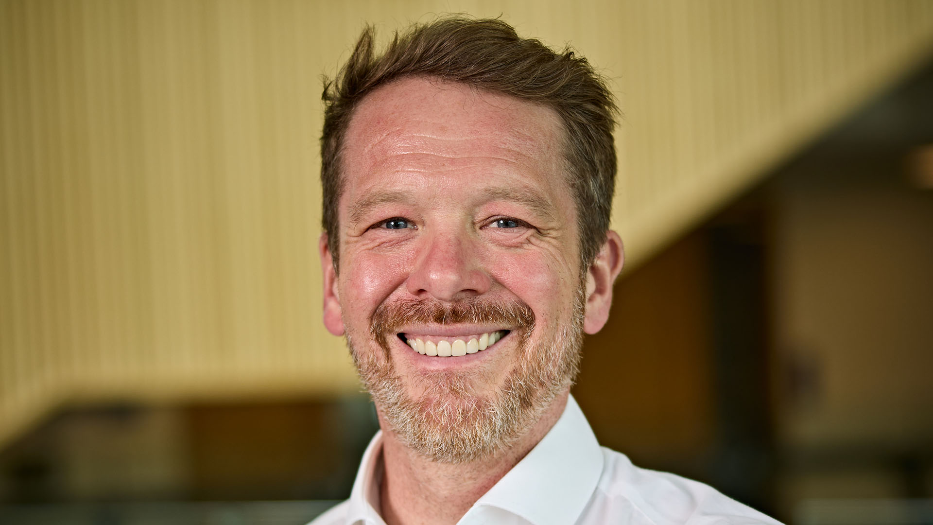 A headshot of Philip Brown, he is smiling at the camera