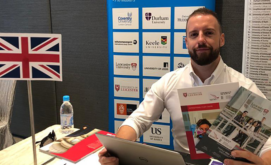 Aaron sat behind a table at a career fair.