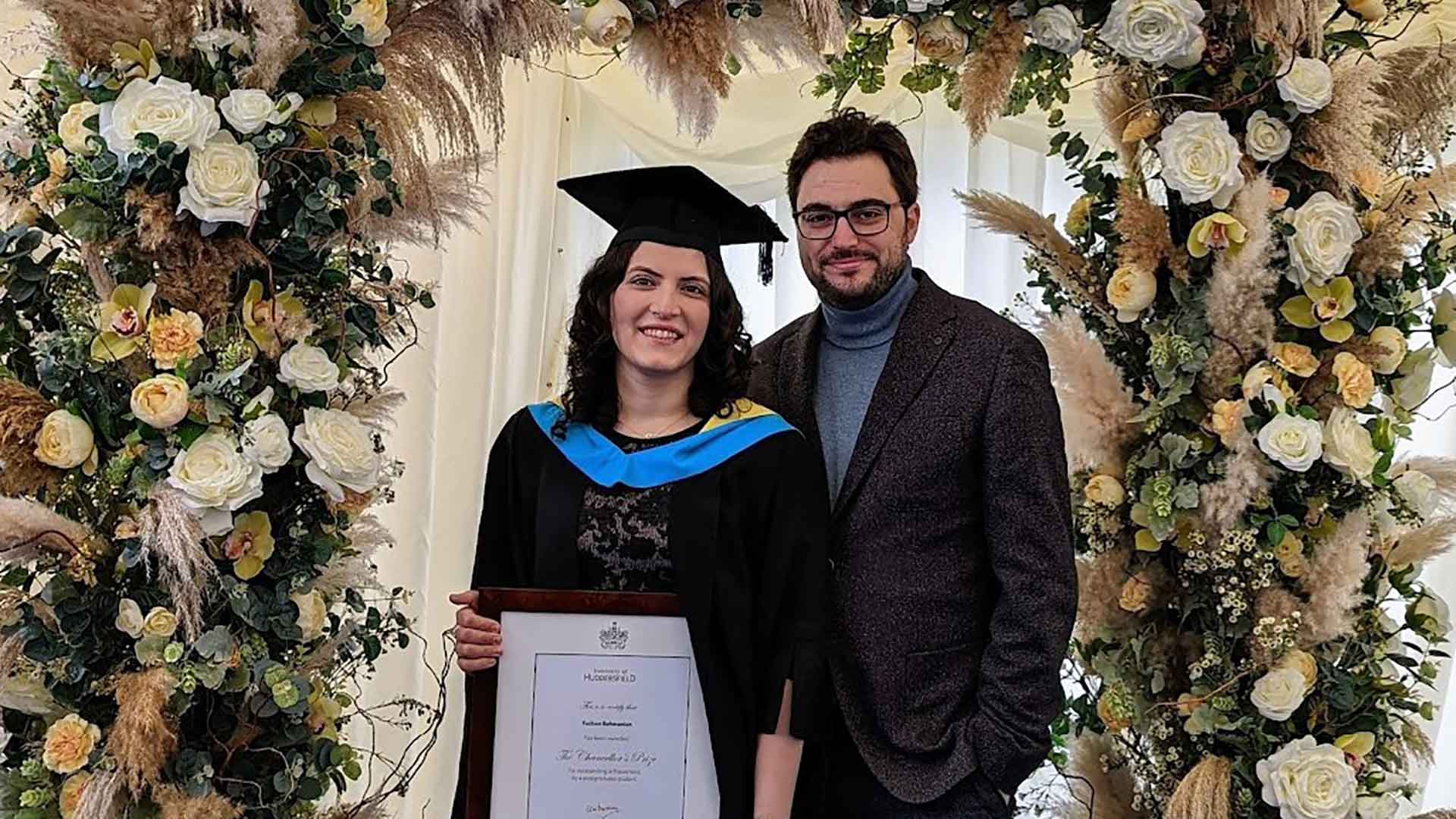 Fuzhan and her fiancé stood together at her graduation ceremony.