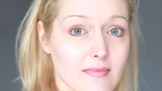 Rea looking at the camera.