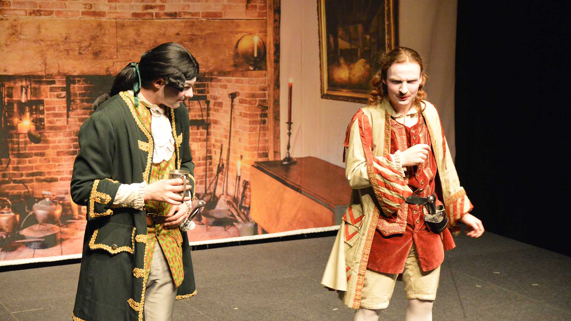 Two students performing in full costume, during a live drama showcase