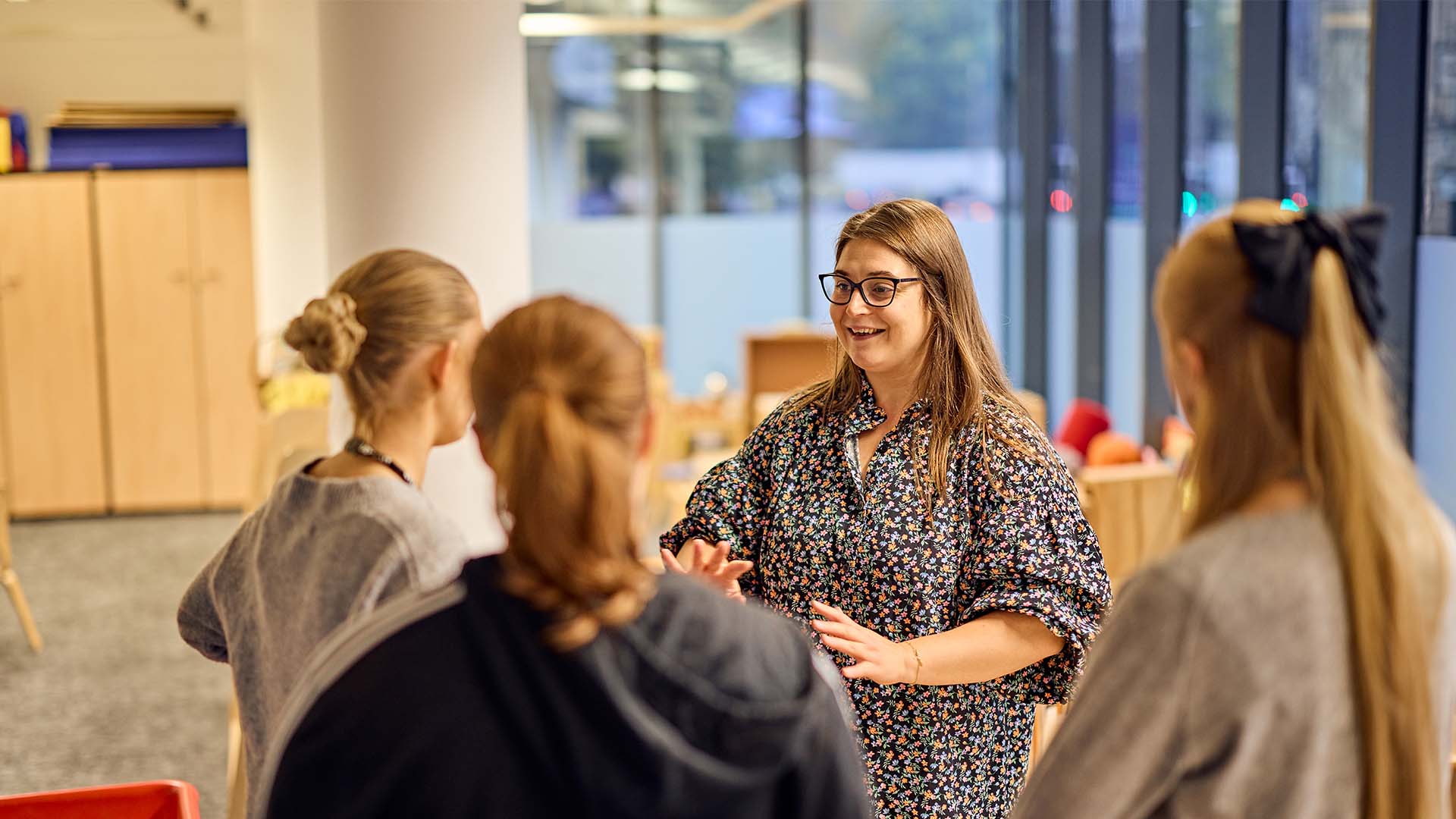 Four teachers having a discussion in a classroom