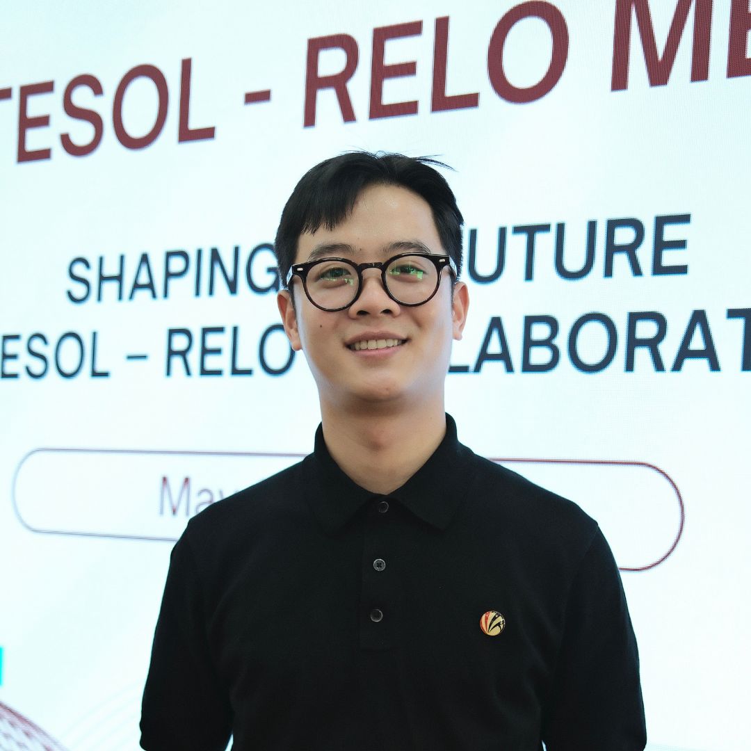 Student standing in front of presentation smiling