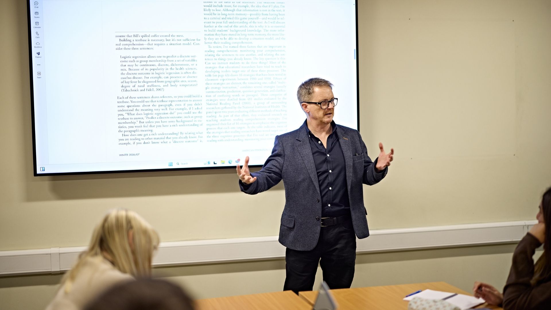 Teacher delivering a lesson to students in classroom