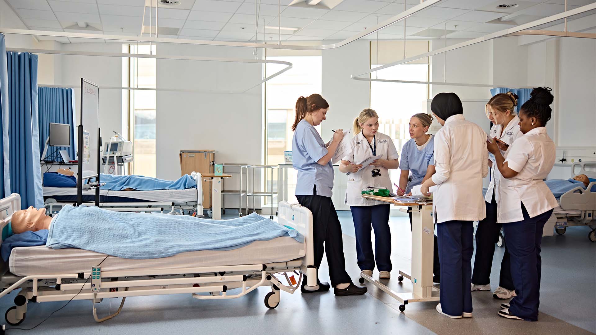 Team of student nurses working together to discuss a patient