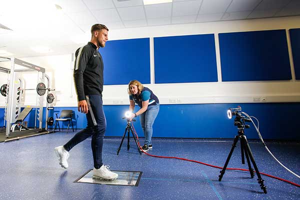 A student walks on a force plate