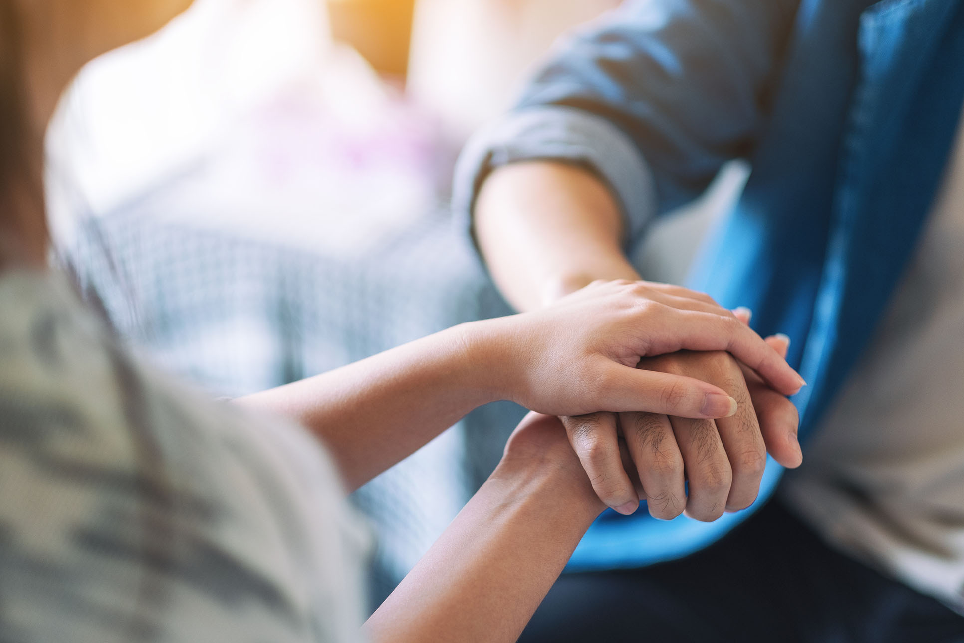 A hand being held gently and comfortingly