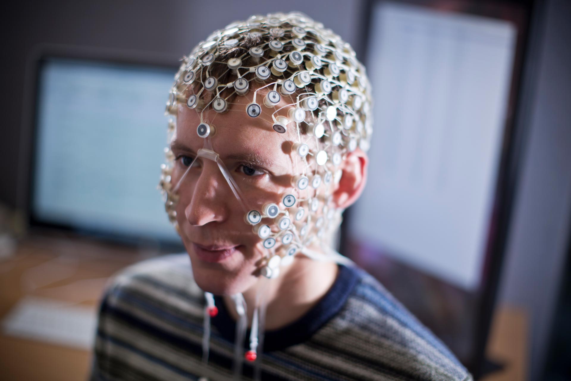 Photo of a person wearing an EEG net