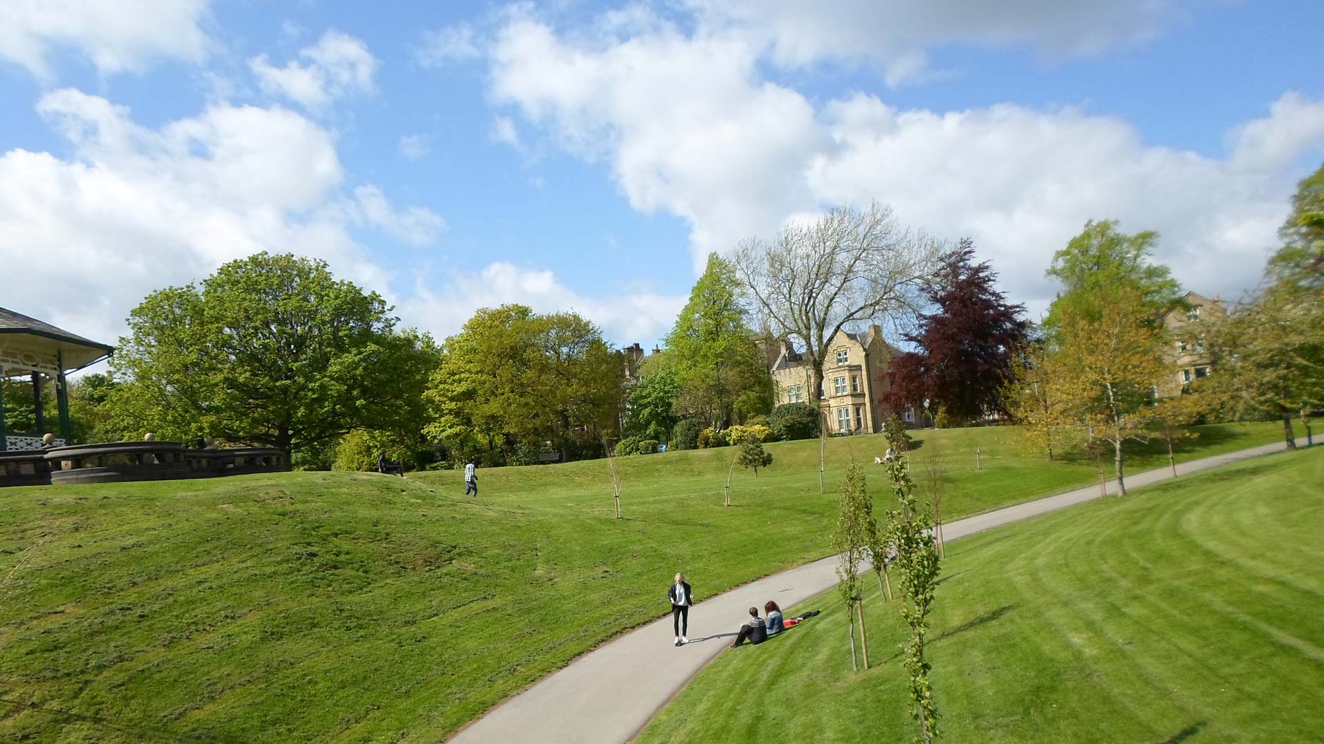 Picture of the lawn behind the band stand in Greenhead Park. In the background you can see large houses