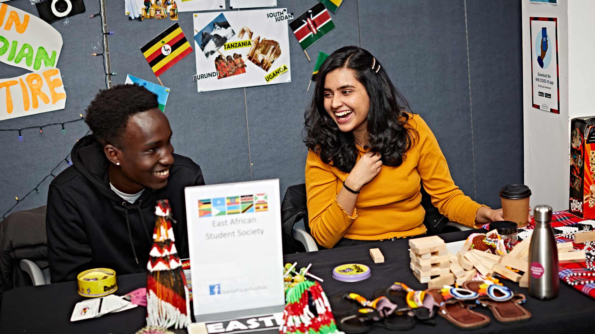 Students sit together on a stand at the Cultural Exchange Day event. 