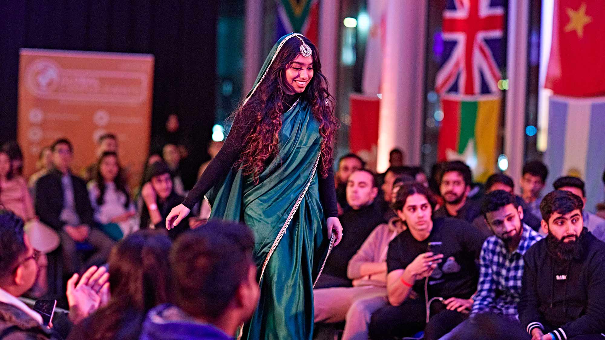 A student walks down the catwalk at the Global Fashion Show. 