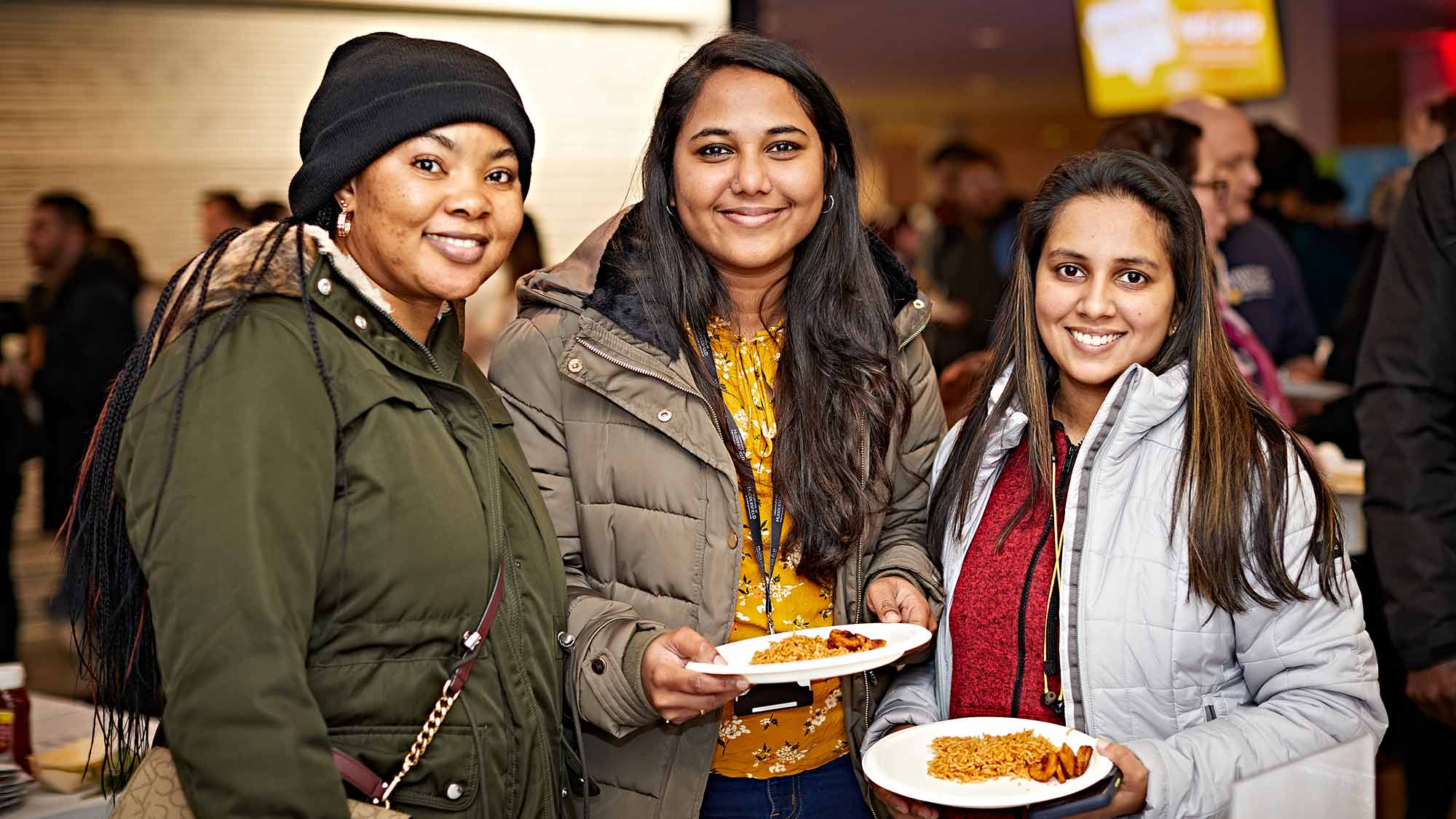 A group of students stand together at the Global Food and Culture Festival. 