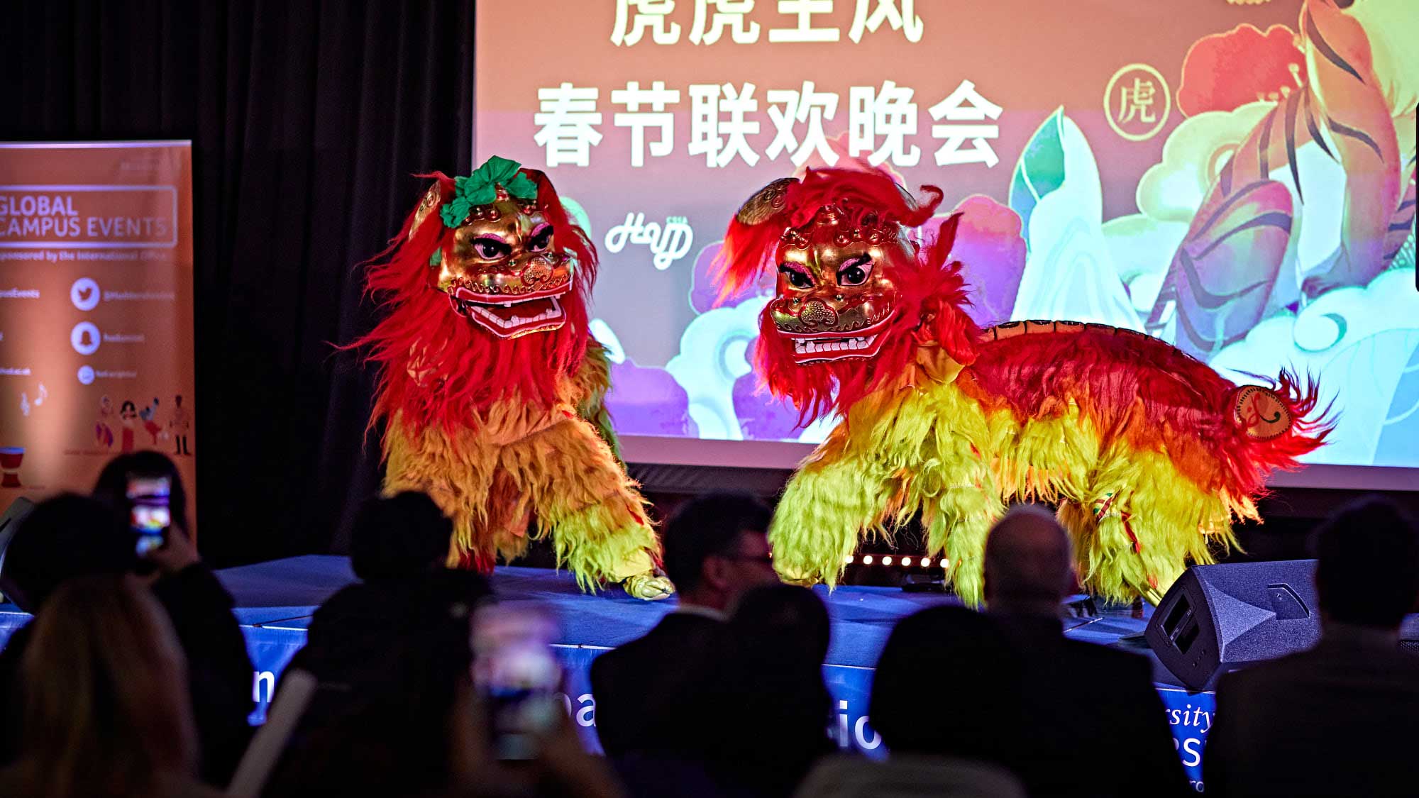 Two Chinese lions do the lion dance on stage at the Chinese Evening Gala.