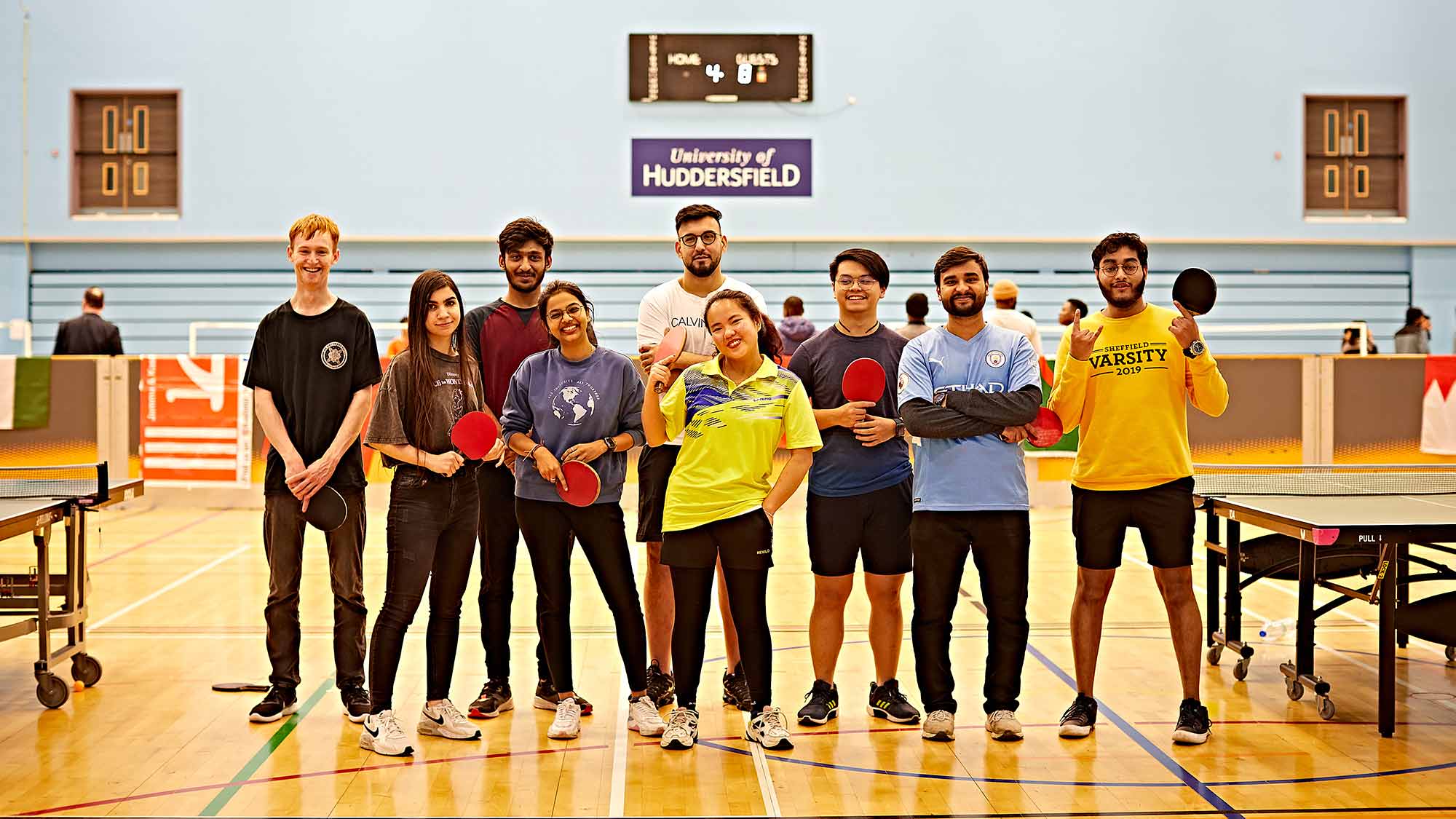 A group of students stand together after taking part in the world of sports tournament 