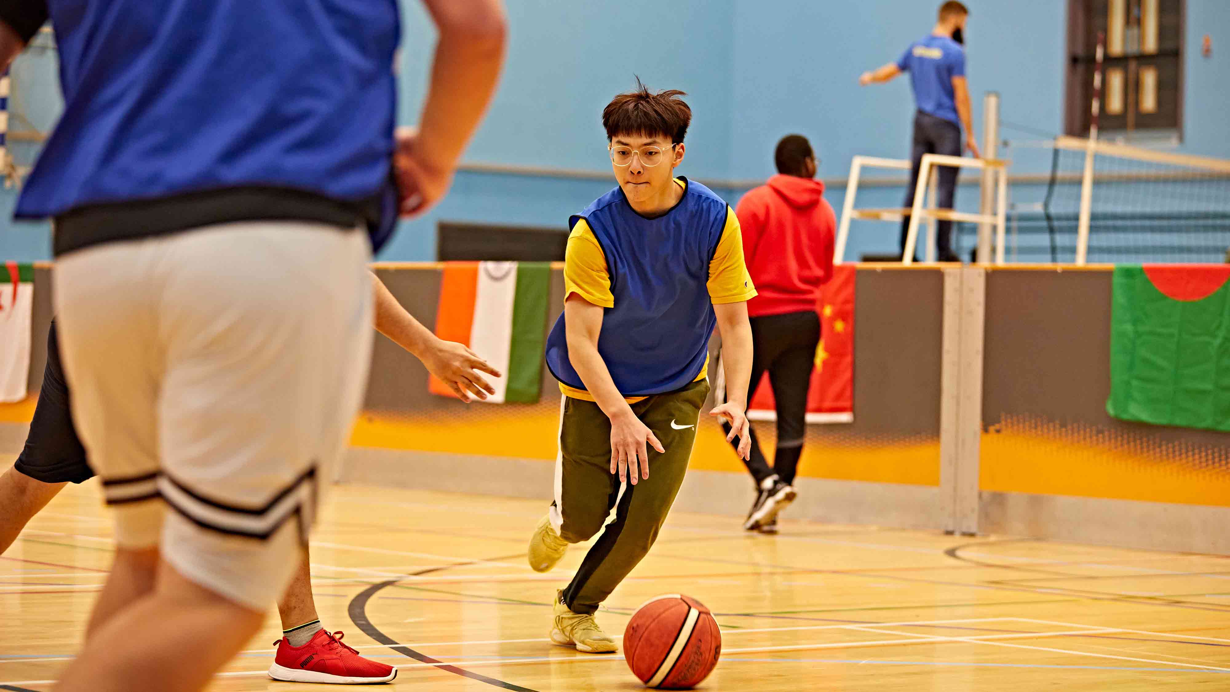 A student dribbles a ball as part of the world of sports tournament 