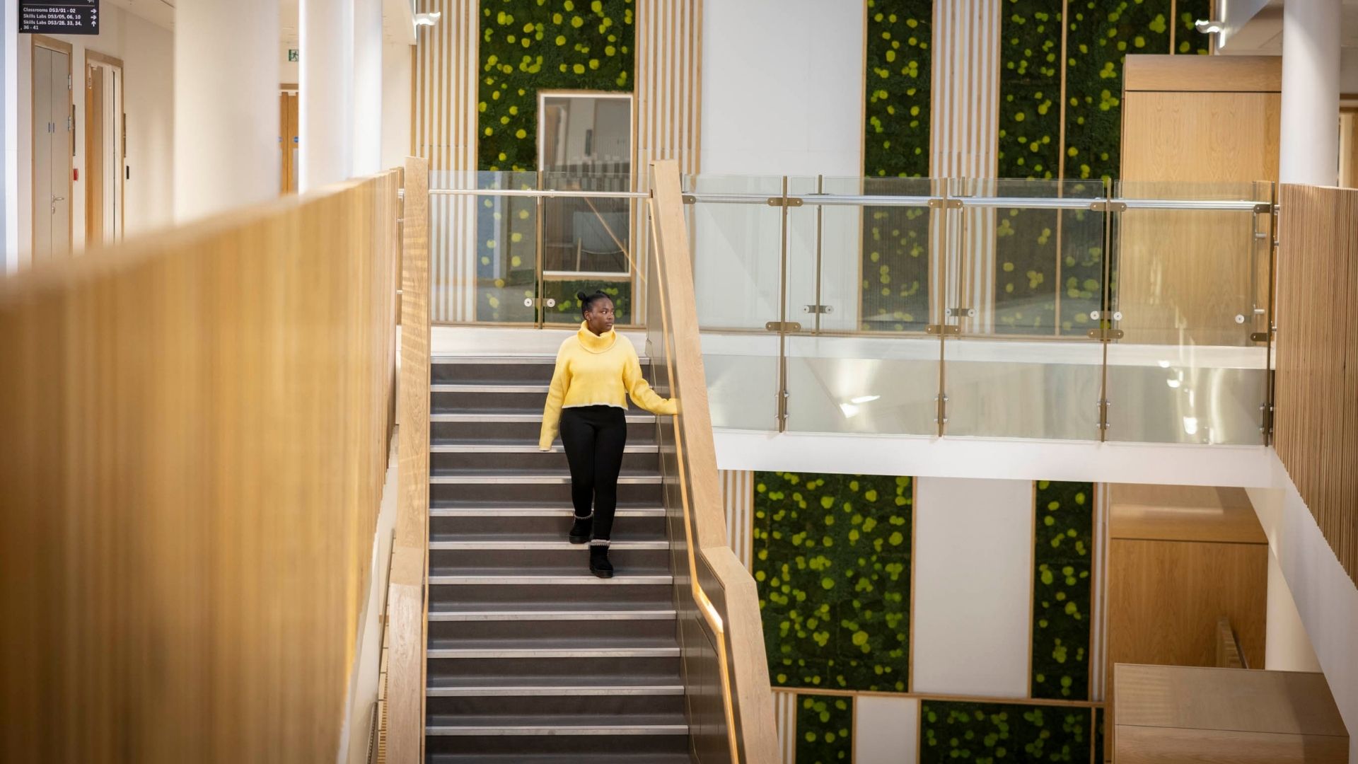 Student walking down stairs in our Oastler building
