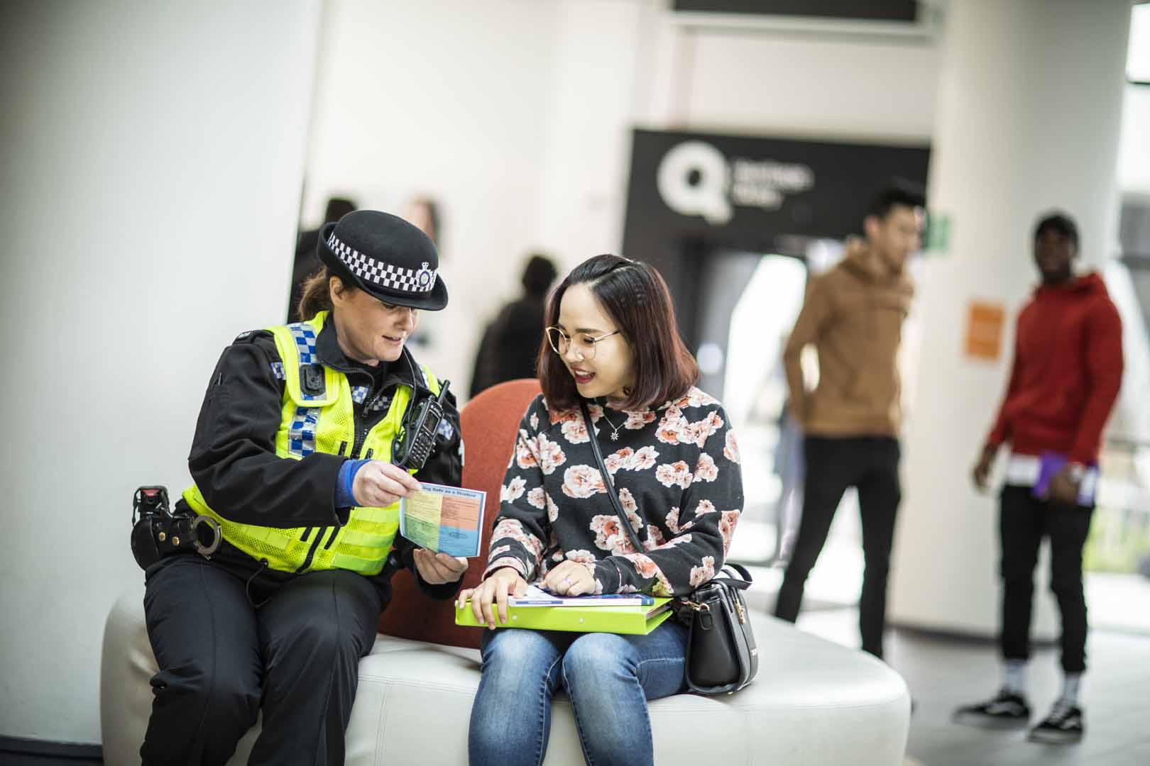 A student sat next to a police officer.