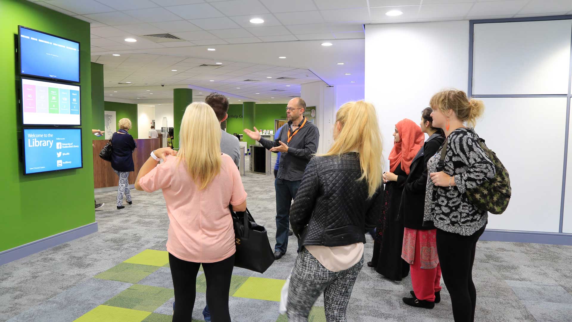 Picture of students being shown the entrance of the Library.