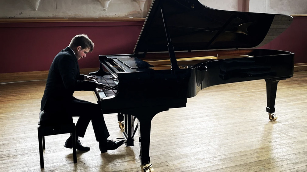 Wide shot of Stephen Gott performing a piano solo