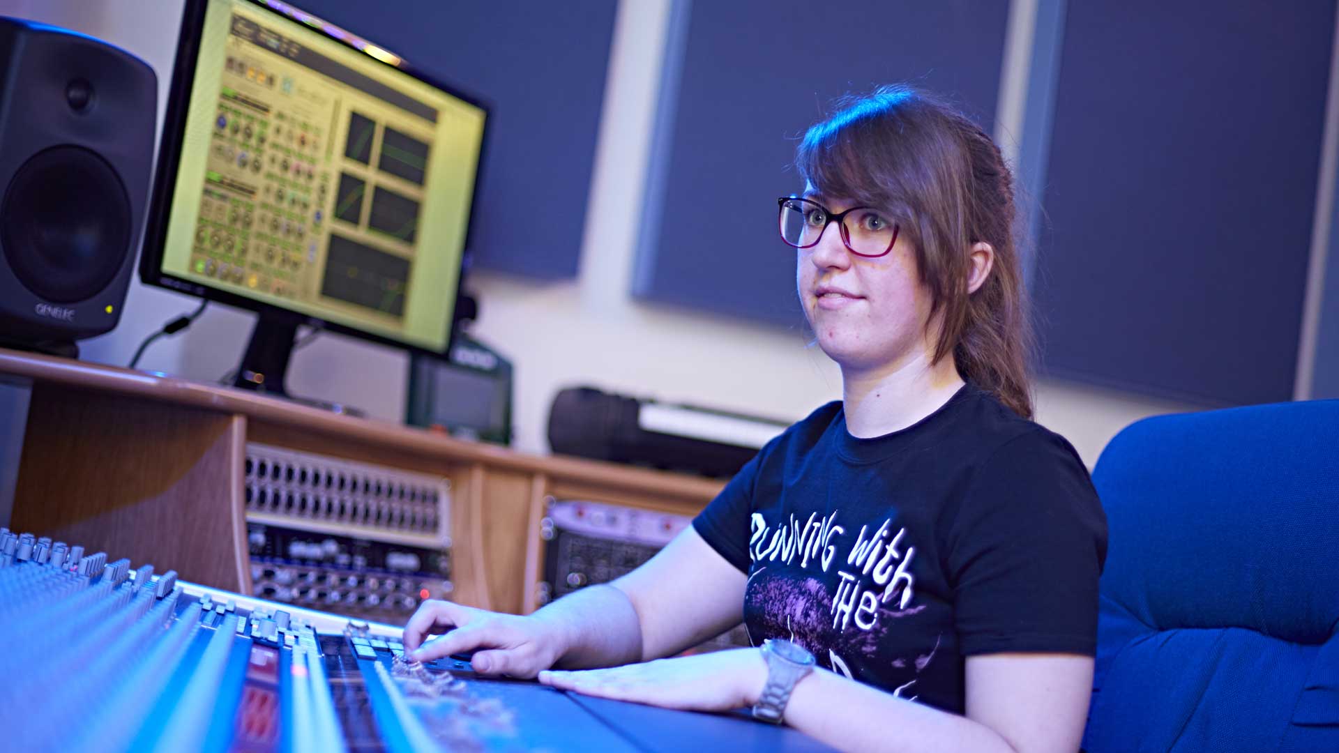 Student sat at a mixing desk.