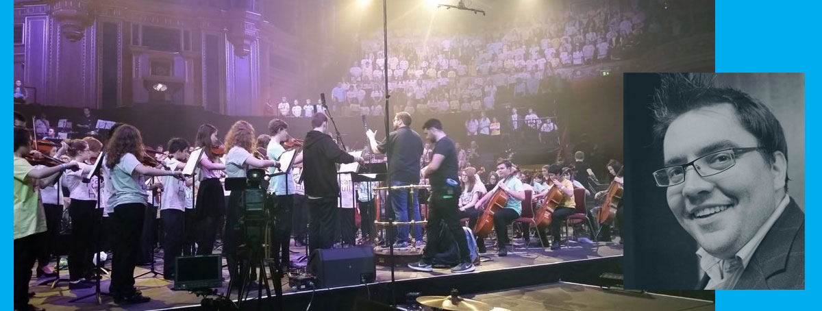 Pictured Huddersfield alumnus Sam Dunkley takes charge at the podium during rehearsals at the Albert Hall