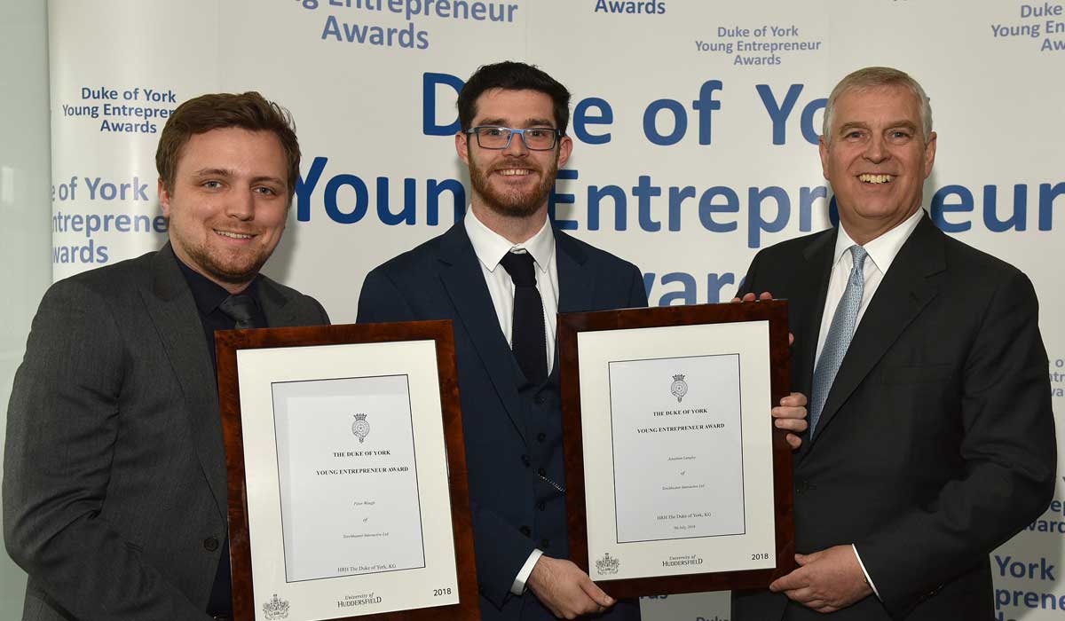 Torchbearer's Pete Waugh (left) and Jonathan Langley (centre) receive their awards from HRH The Duke of York (right)