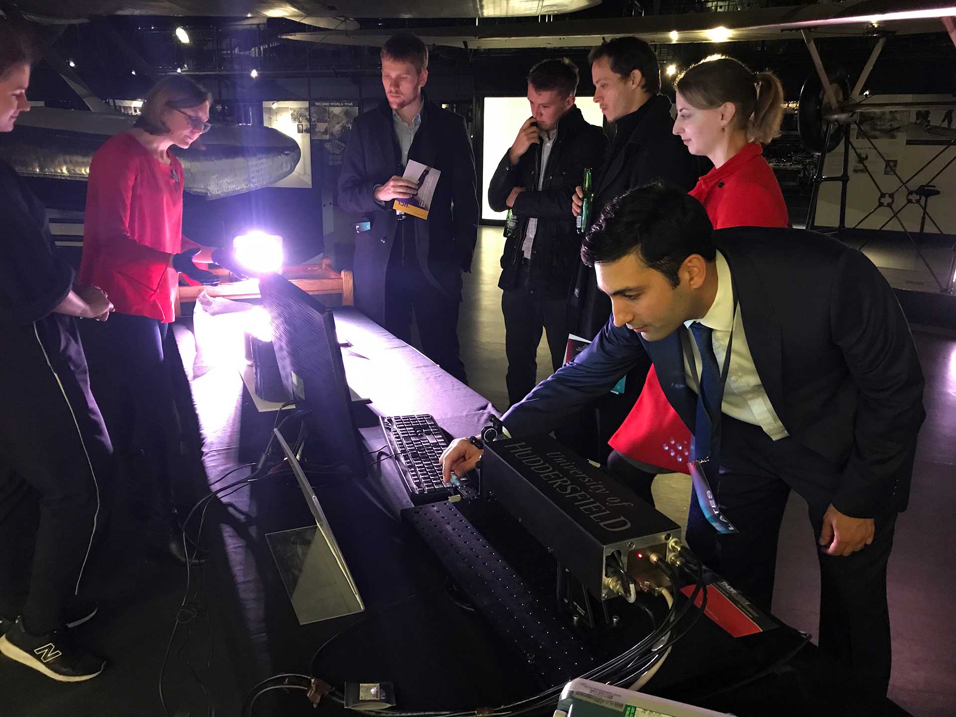 The University's Dr Muhamedsalih demonstrating the optical interferometry system to the museum's visitors