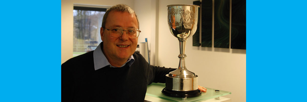 Professor John Allport with the cup he received for his prize-winning paper 'Active Charge Cooling'