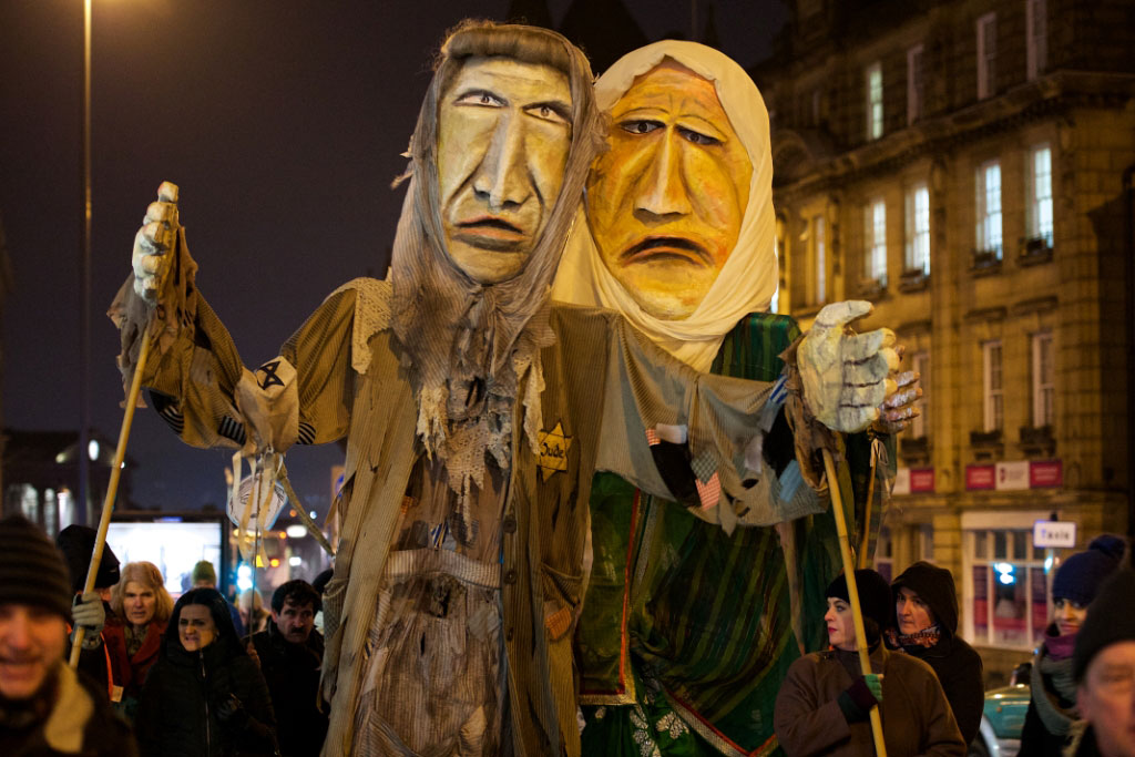 image of puppets on procession for Holocaust Memorial Day