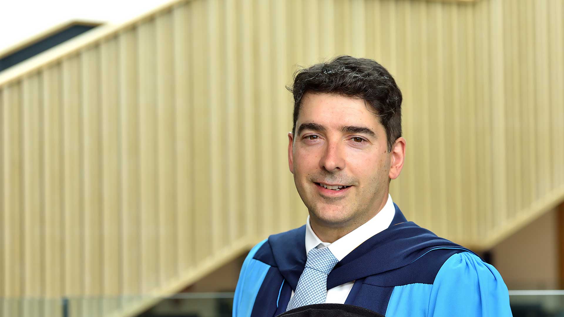 John Bernard wearing his honorary graduation gown
