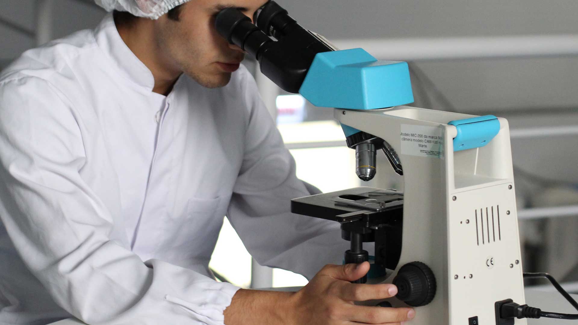 a student looking down a microscope