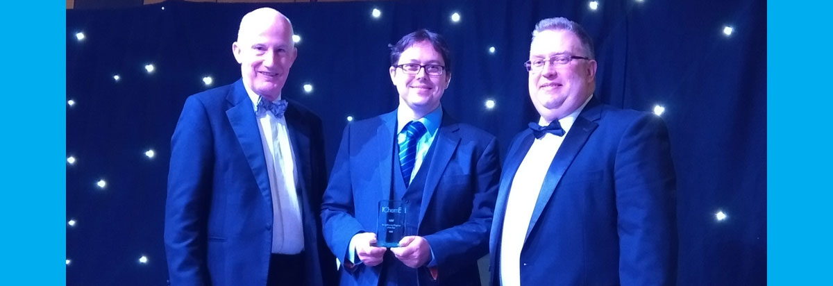 The University’s Dr Daniel Belton (centre) receives his award