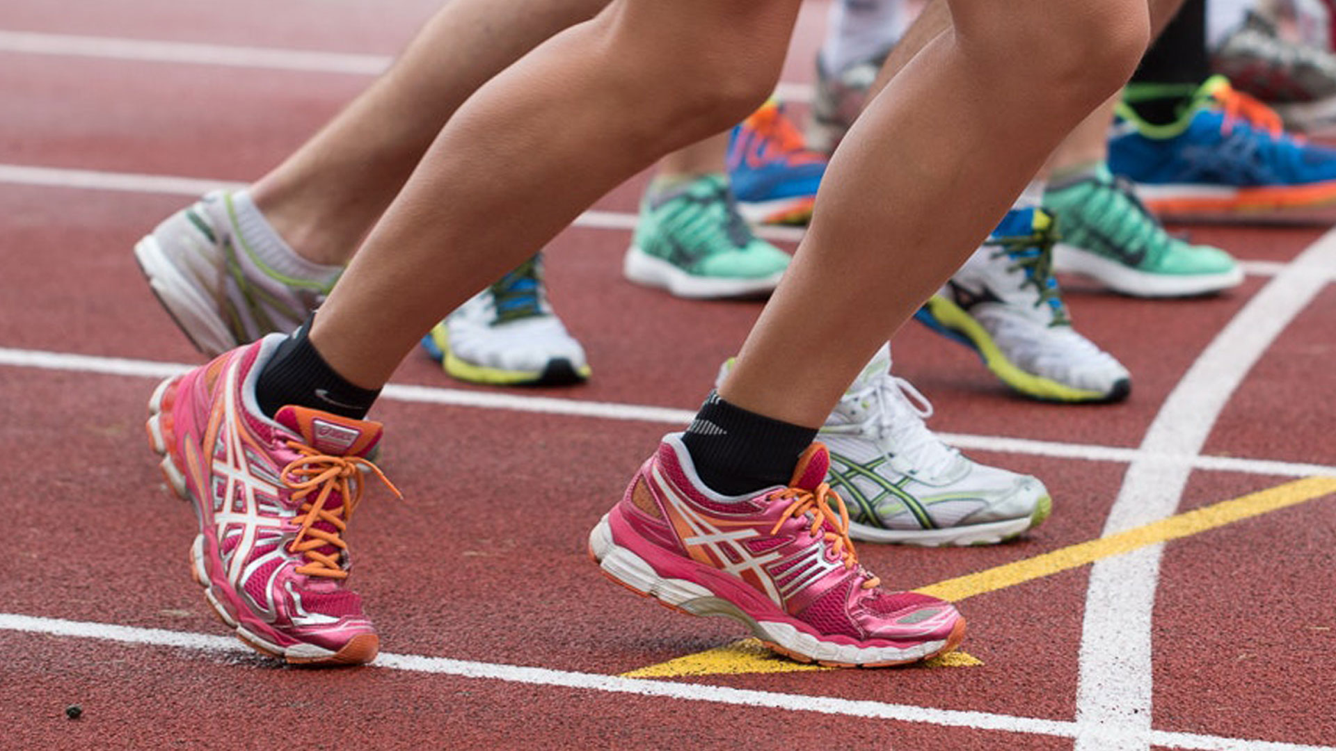 athlete's running shoes at the start of a race on a race track