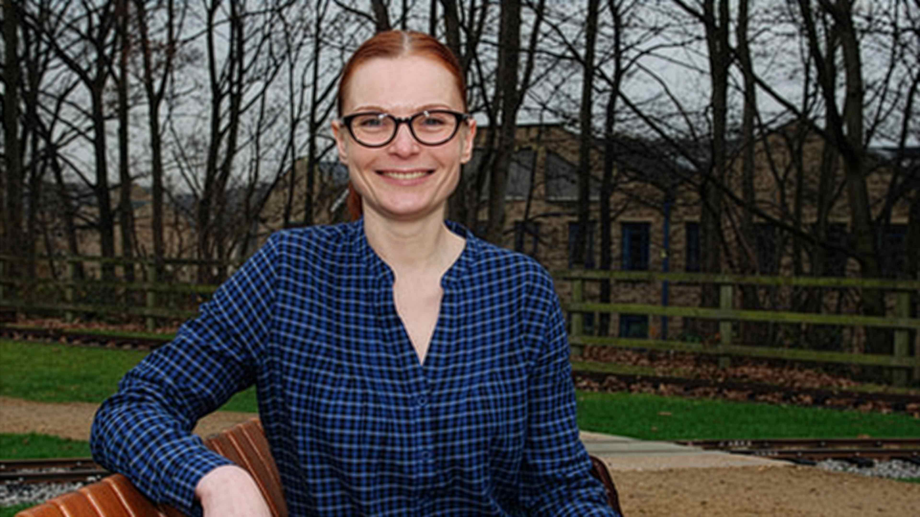 a woman sitting on a bench outside