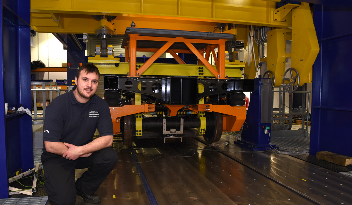 The Institute of Railway Research’s IRR’s Test Applications Engineer Barnaby Bryce with the FORESEE project prototype chassis on the University’s test rig.