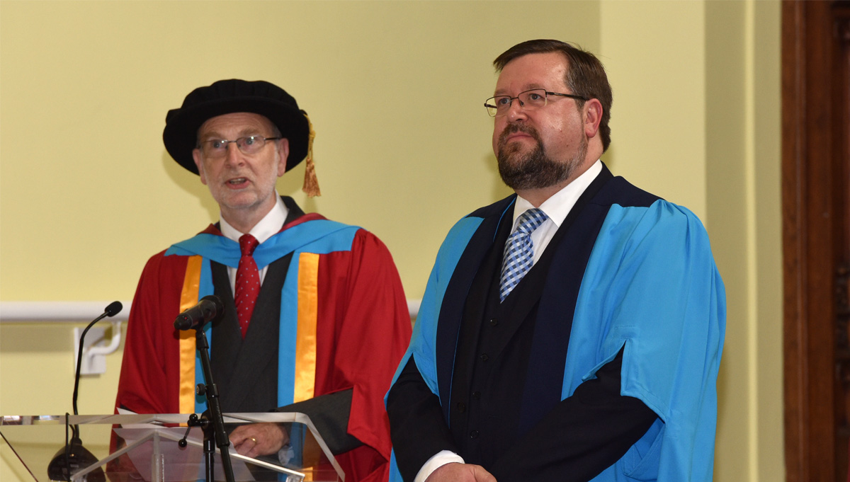 Gavin Sutherland (right), conductor, composer, arranger and Huddersfield graduate receives an Honorary Doctorate of the University of Huddersfield.  He is pictured with his award orator, the University's Professor John Bryan (left).