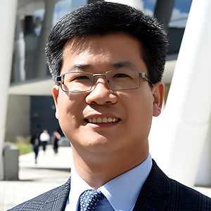Dr Zhen Tong smiling looking at the camera