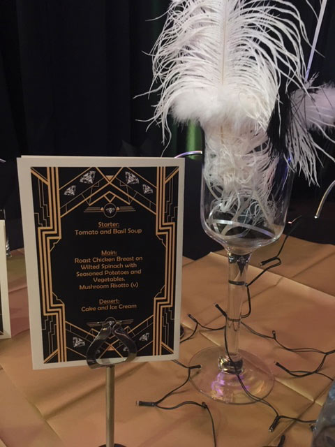 Menu and posh glass on a table for the Law School Challenge event