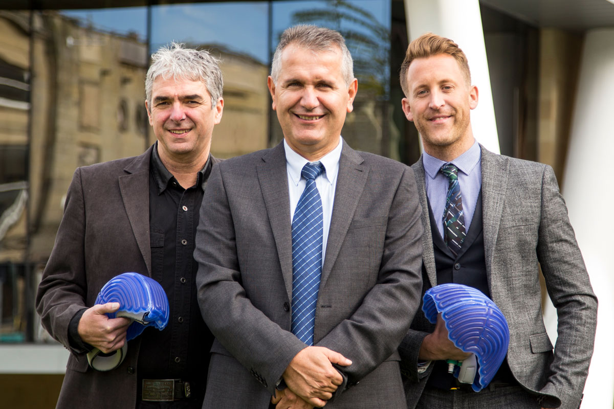 The University's Dr Ertu Unver (centre) is pictured with Paxman's Patrick Burke (left) and Richard Paxman (right)